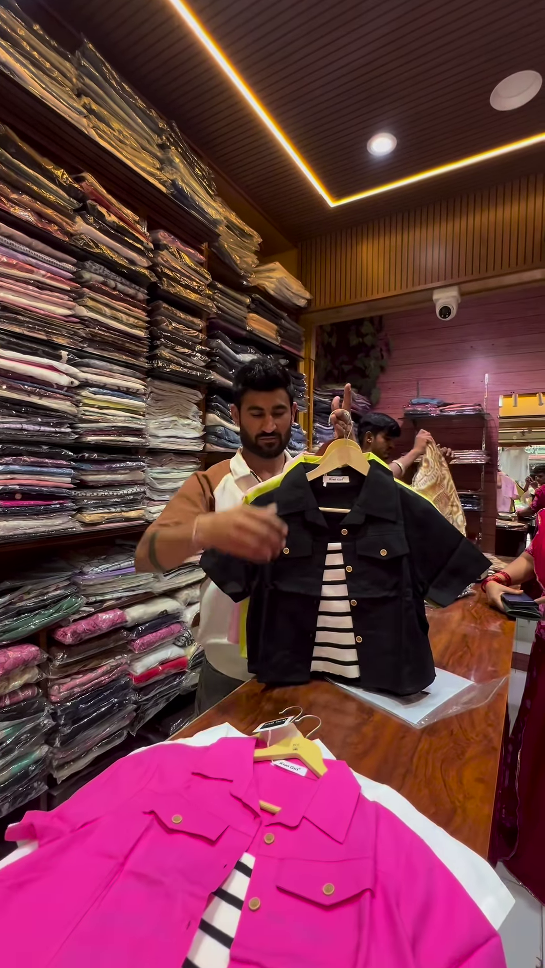 White Buttoned Utility Jacket with Chest Flap Pockets over Striped Inner Layer - Image 4